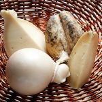 Basket of fresh sliced and whole Provolone cheese