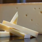 Closeup shot of French Gruyere cheese and baguette bread