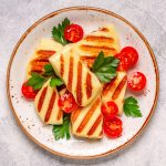 Grilled halloumi cheese served with tomatoes and parsley