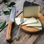 Spanish cured cheese with rustic background